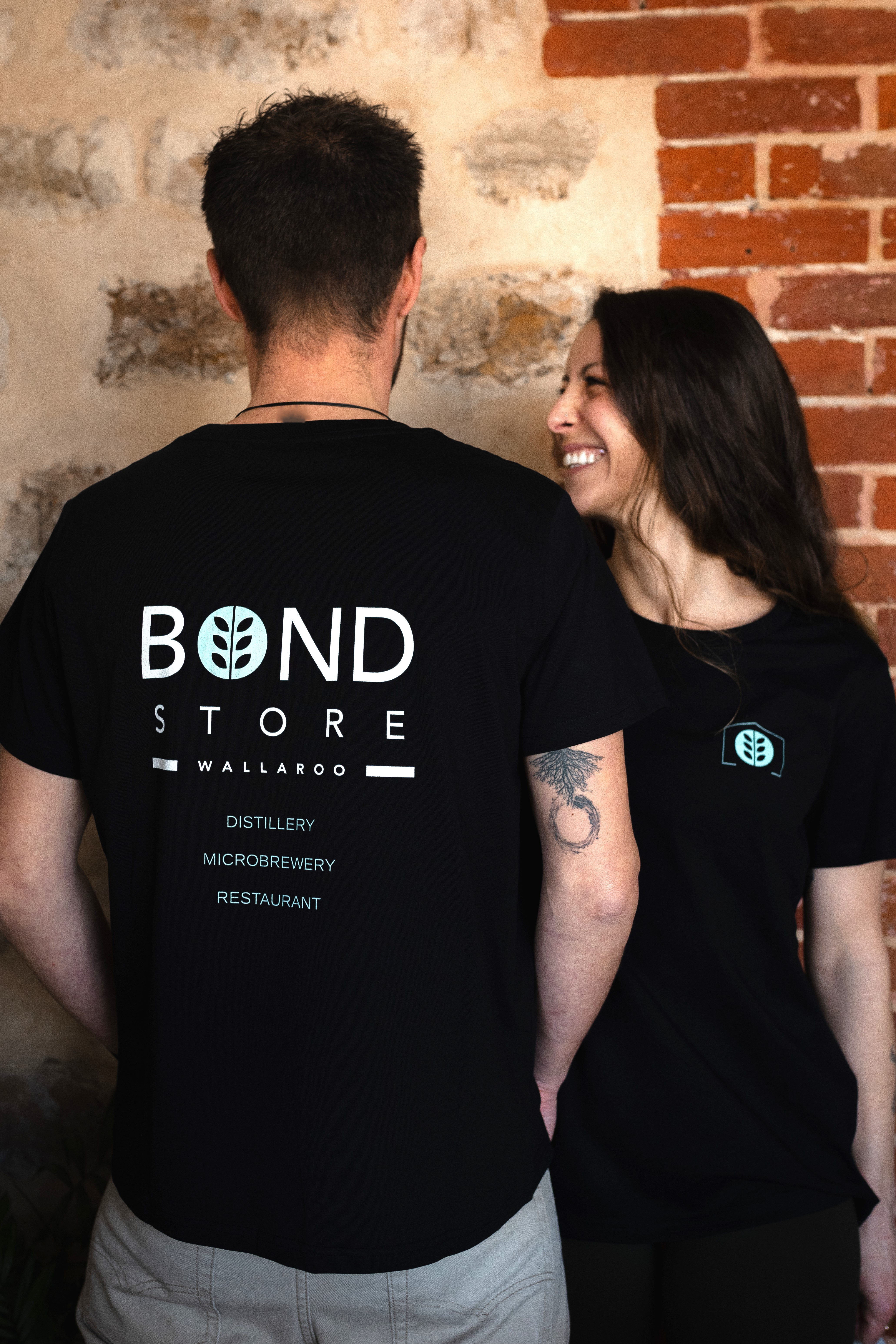 two people wearing bond store Tee